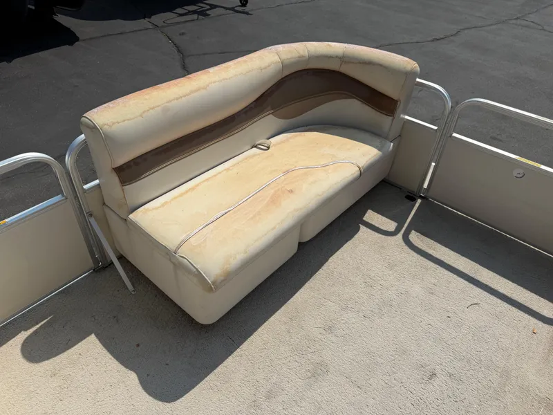 Slide: The Image of Worn seating on 2006 Sweetwater 23860DF boat, showing sun damage and discoloration. - 10