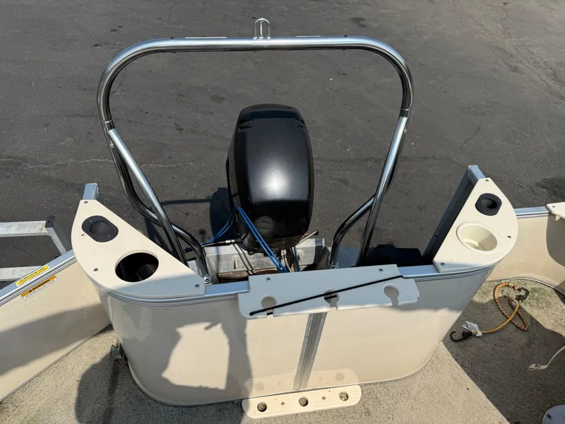 Slide: The Image of 2006 Sweetwater 23860DF boat engine area with cup holders and railing. - 13