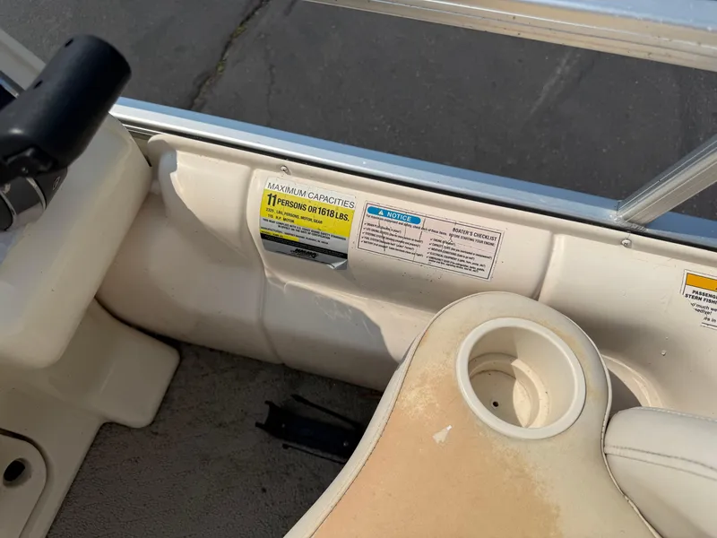 Slide: The Image of Boat interior showing capacity label for 11 persons or 1618 lbs, Sweetwater 23860DF, 2006 model. - 17