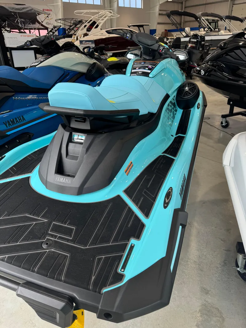 Slide: The Image of 2025 Yamaha WaveRunner VX Limited HO in showroom, turquoise and black design. - 2