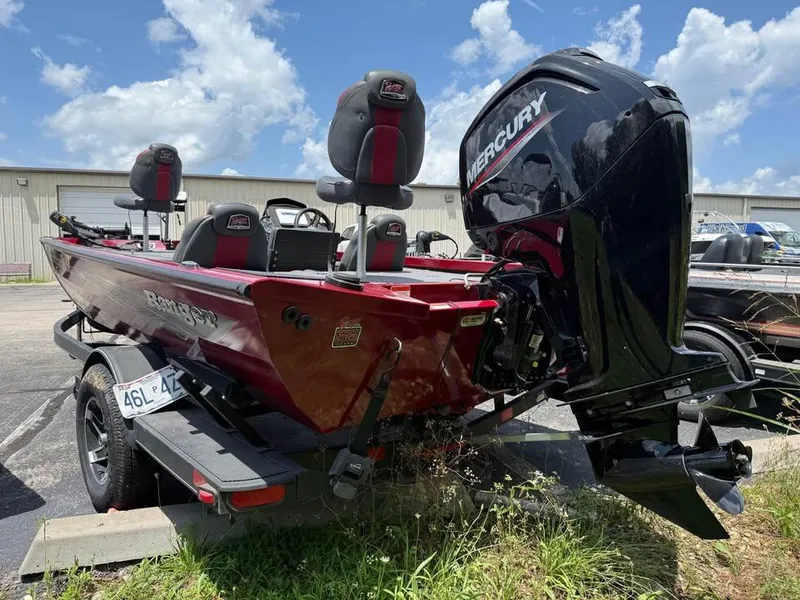 Slide: The Image of 2023 Ranger RT 188 boat with Mercury engine, parked outdoors under a blue sky. - 5