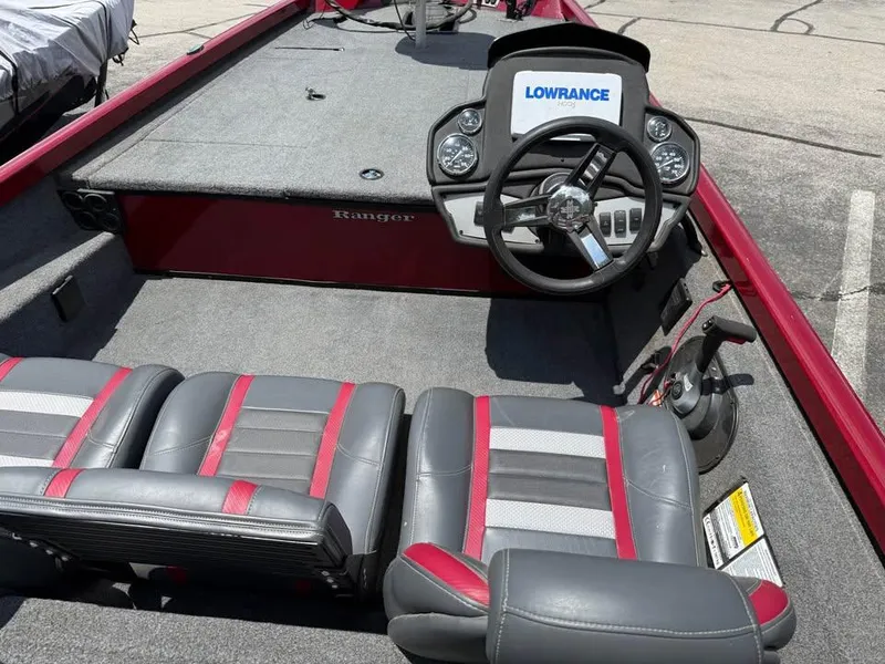 Slide: The Image of 2023 Ranger RT 188 boat interior with steering wheel and seats, featuring Lowrance electronics. - 9
