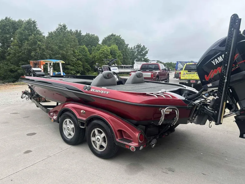 Slide: The Image of 2009 Ranger Z520 boat with Yamaha engine on trailer, parked outdoors. - 2