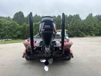 Slide: The Image of 2009 Ranger Z520 boat with powerful outboard motor, parked outdoors on concrete surface. - 4