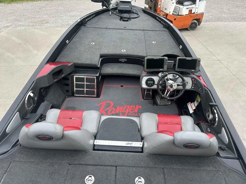 Slide: The Image of 2009 Ranger Z520 boat interior with red and gray seating, steering wheel, and electronic displays. - 5