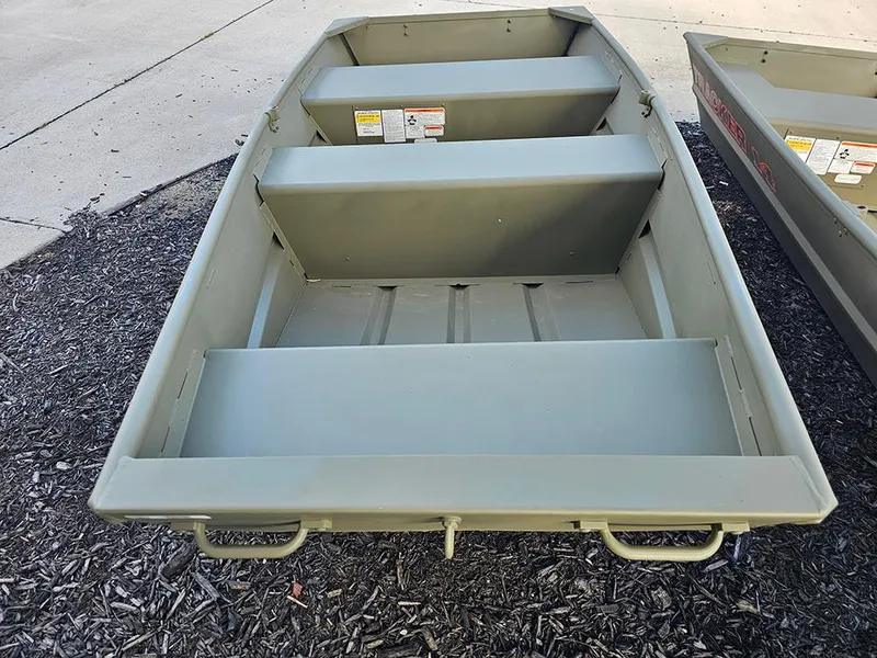 Slide: The Image of 2026 Tracker Grizzly 1036 Utility boat on display, showcasing interior seating and design. - 2