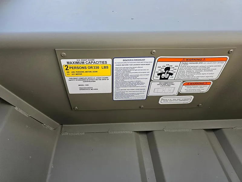 Slide: The Image of 2026 Tracker Grizzly 1036 Utility boat capacity and safety warning labels. - 4