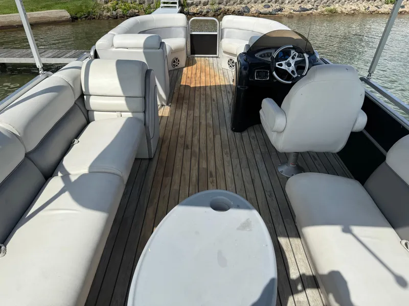 Slide: The Image of Interior of a 2000 Sanpan 25 pontoon boat with spacious seating and wooden deck. - 15