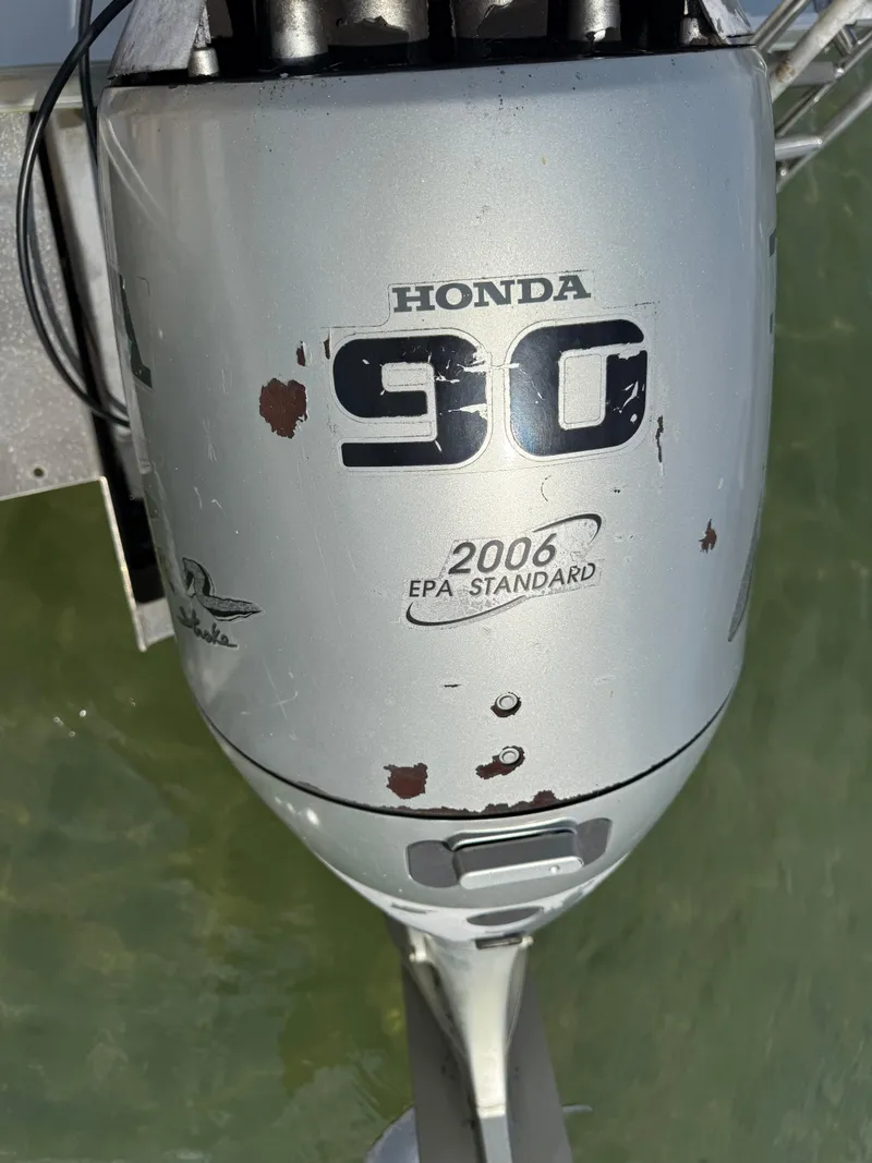 Slide: The Image of Silver Honda 90 outboard motor with visible wear, labeled "2006 EPA Standard." - 17