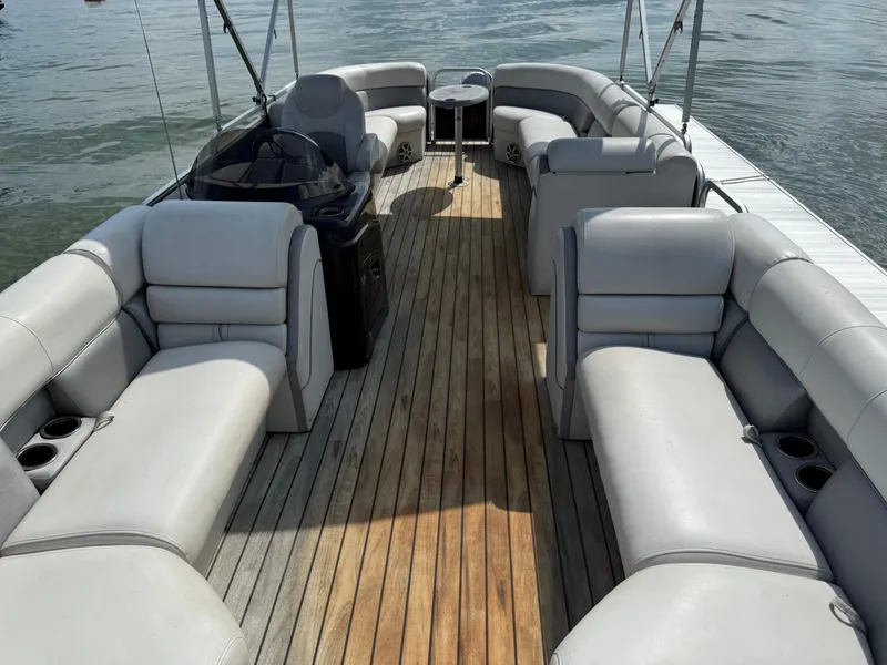 Slide: The Image of Spacious 2000 Sanpan 25 pontoon boat with comfortable seating and wooden deck. - 4