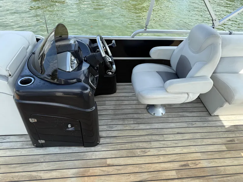 Slide: The Image of Sanpan 25 boat interior, 2000 model, featuring a steering console and comfortable seating on wooden deck. - 8
