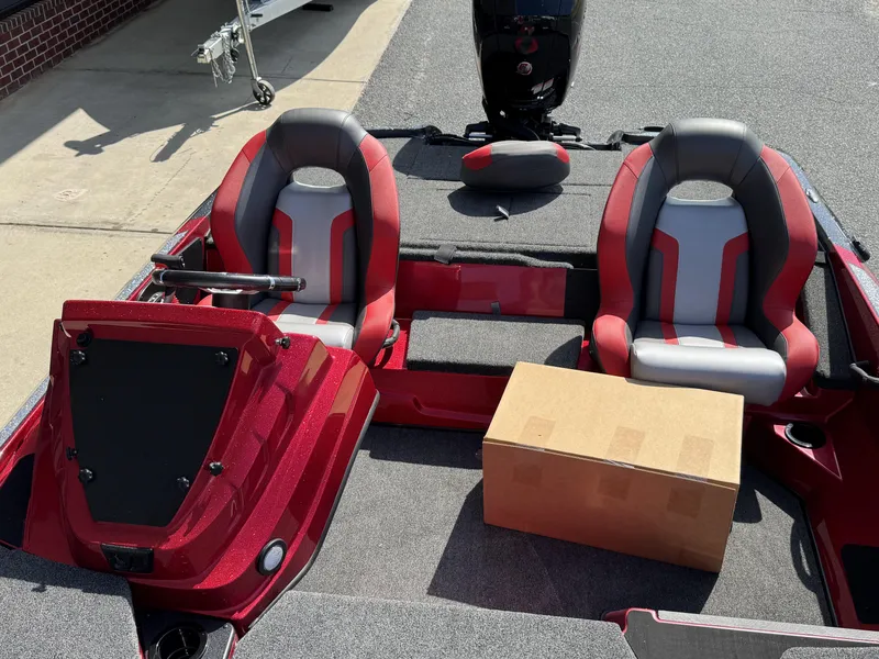 Slide: The Image of Red and gray interior of 2026 Nitro Z18 boat with two seats and a cardboard box. - 10