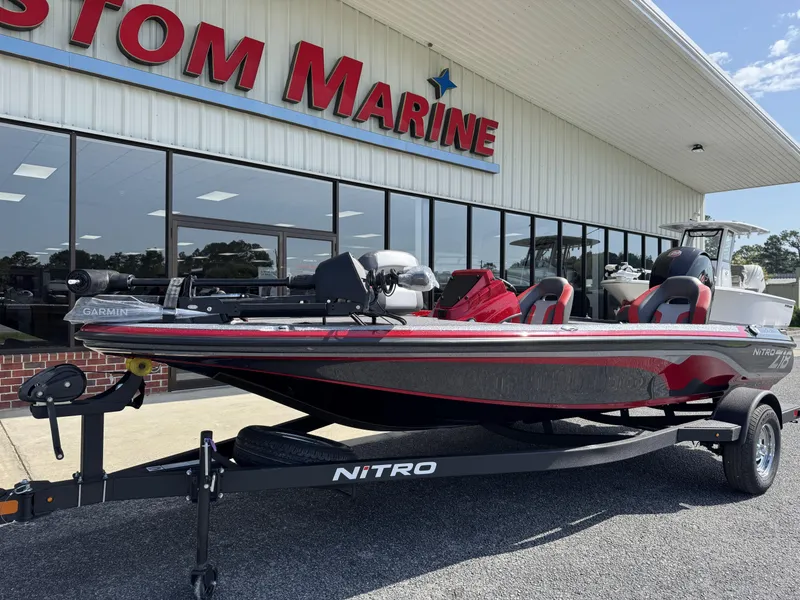 Slide: The Image of 2026 Nitro Z18 boat displayed outside Custom Marine dealership. - 5