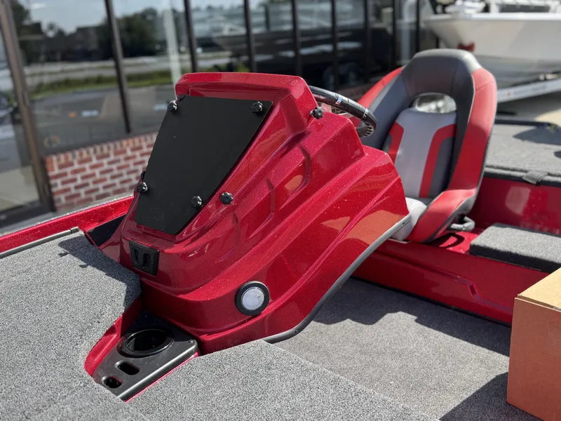 Slide: The Image of Red Nitro Z18 boat interior with steering console, gray seat, and carpeted deck, model year 2026. - 9