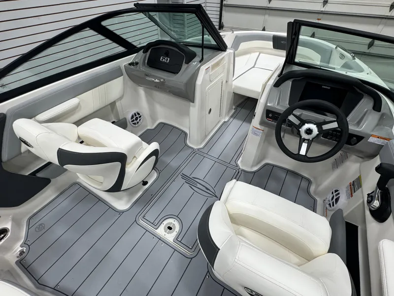 Slide: The Image of 2025 Chaparral 21 SSi boat interior with modern dashboard and white seating. - 10