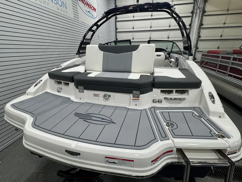 Slide: The Image of 2025 Chaparral 21 SSi boat with sleek design and spacious seating in showroom. - 13