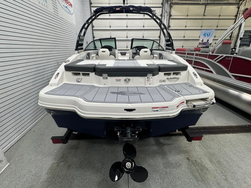 Slide: The Image of 2025 Chaparral 21 SSi boat, rear view in showroom, showcasing sleek design and modern features. - 16
