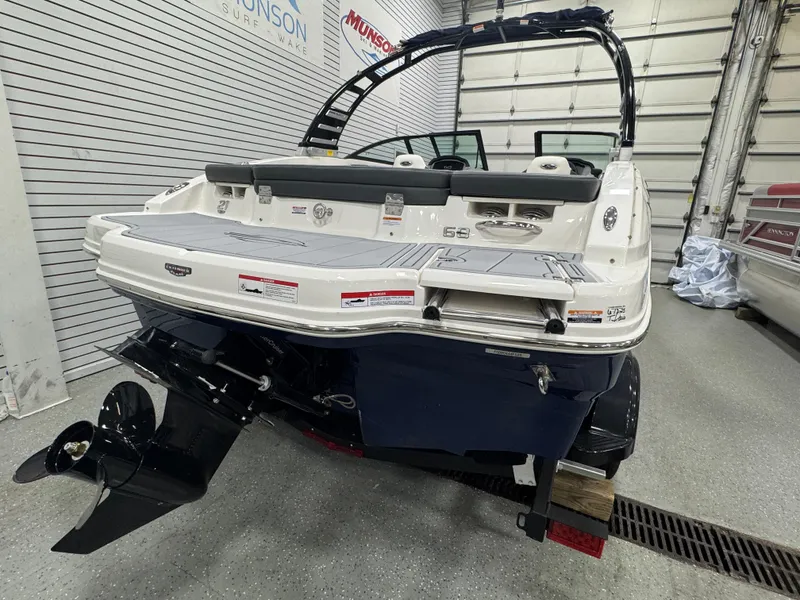 Slide: The Image of 2025 Chaparral 21 SSi boat in showroom, rear view with outboard motor. - 17