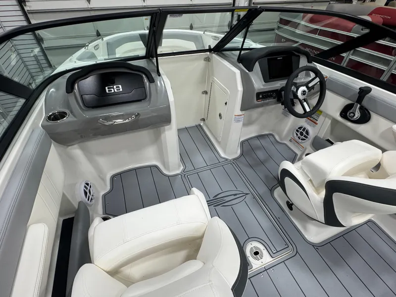 Slide: The Image of 2025 Chaparral 21 SSi boat interior with modern dashboard and white seating. - 4