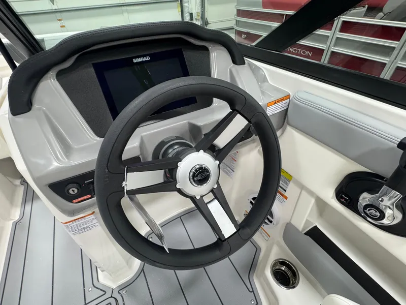Slide: The Image of 2025 Chaparral 21 SSi boat dashboard with steering wheel and Simrad display. - 5