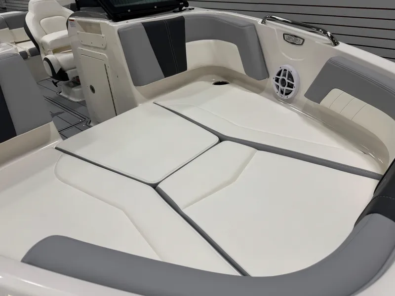 Slide: The Image of 2025 Chaparral 21 SSi boat interior with cushioned seating and speaker system. - 6