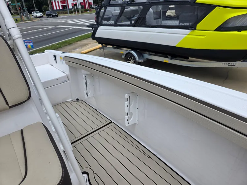 Slide: The Image of 2025 Yamaha Boats 195 FSH Sport interior with beige seating and sleek deck design. - 10