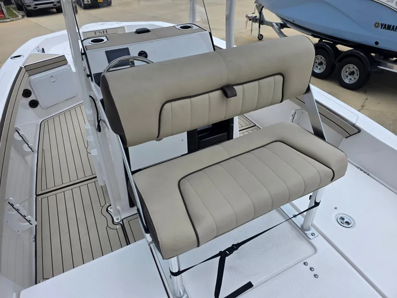Slide: The Image of 2025 Yamaha Boats 195 FSH Sport interior with beige seating and modern dashboard. - 13