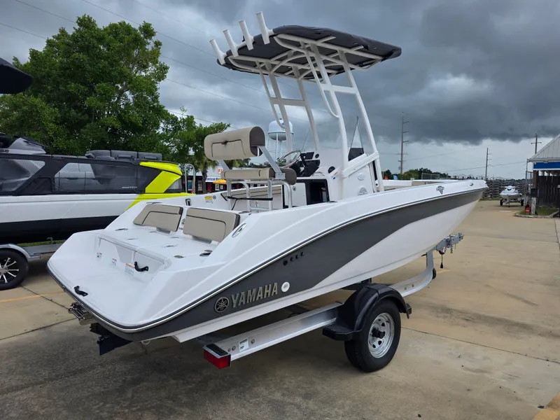 Slide: The Image of 2025 Yamaha Boats 195 FSH Sport on trailer, parked outdoors under cloudy sky. - 3