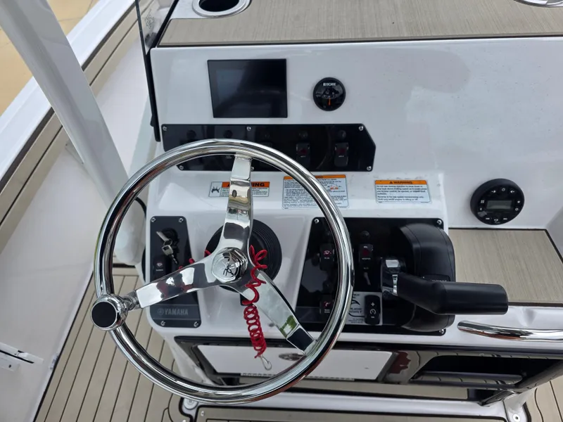 Slide: The Image of Steering console of 2025 Yamaha Boats 195 FSH Sport, featuring controls and gauges. - 9