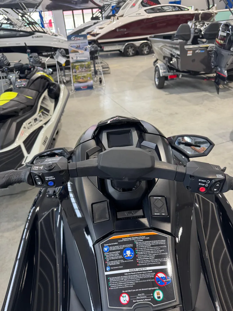 Slide: The Image of 2024 Yamaha WaveRunner GP1800R SVHO dashboard in showroom, surrounded by various watercraft. - 3
