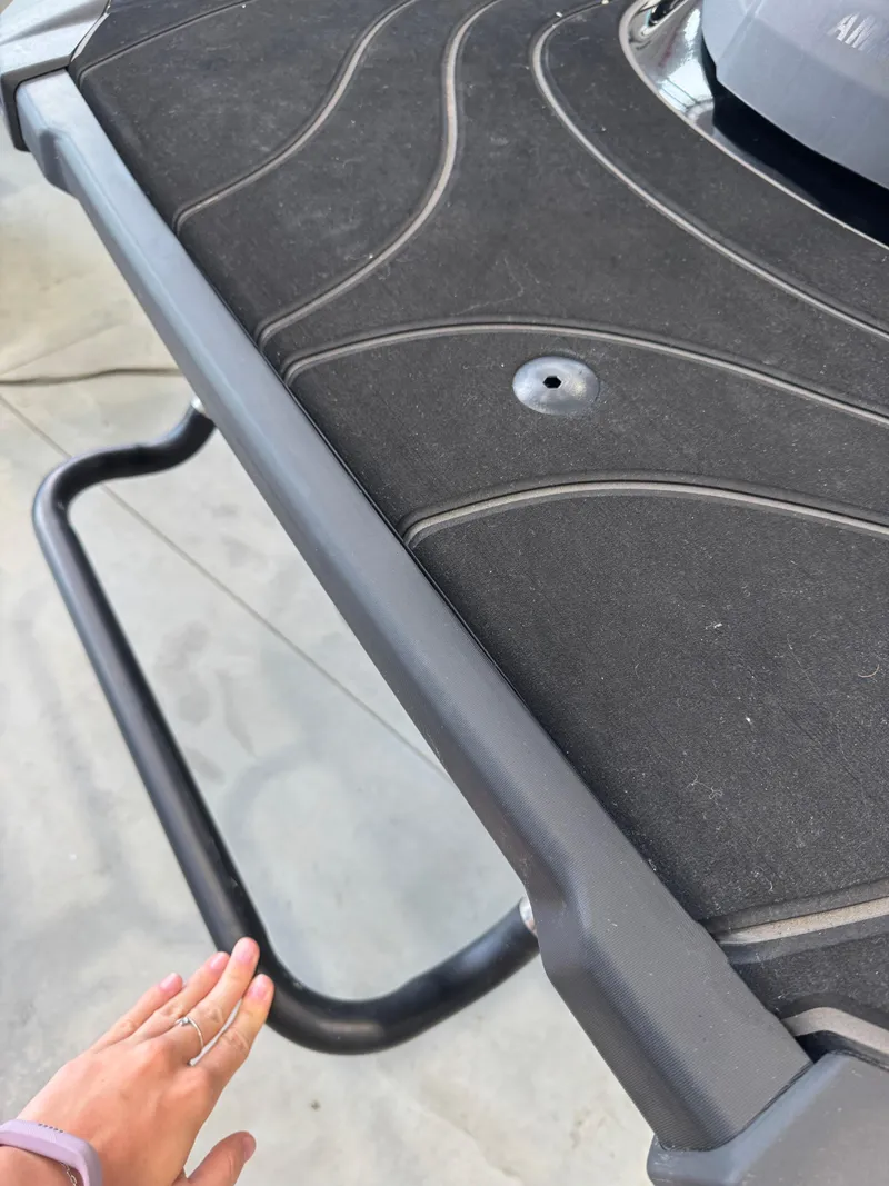 Slide: The Image of 2024 Yamaha WaveRunner GP1800R SVHO rear platform with hand touching the edge. - 5