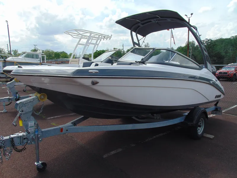 Slide: The Image of 2020 Yamaha Boats 195S on trailer, parked outdoors under cloudy sky. - 2