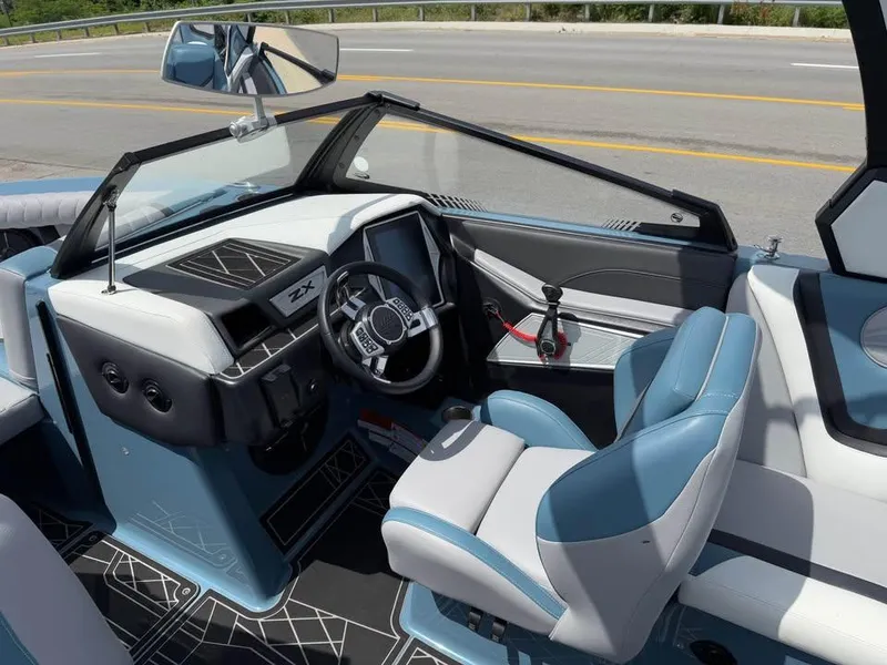 Slide: The Image of 2022 Tigé 21ZX boat interior with modern dashboard and blue seating. - 10