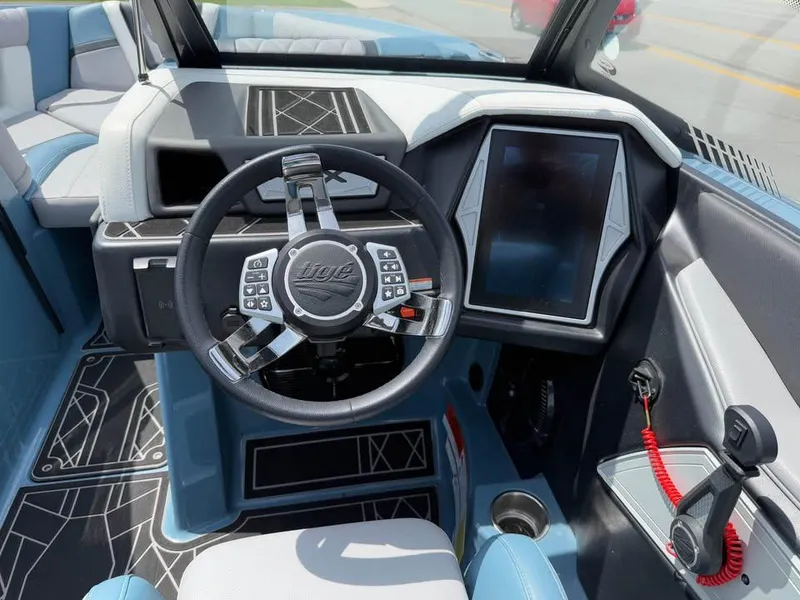 Slide: The Image of 2022 Tigé 21ZX boat interior with modern steering wheel and touchscreen display. - 11