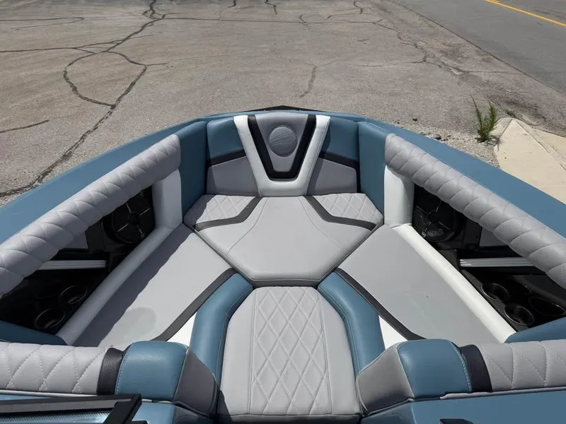 Slide: The Image of 2022 Tigé 21ZX boat interior with blue and gray cushioned seating. - 13