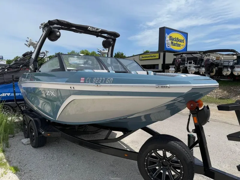 Slide: The Image of 2022 Tigé 21ZX boat on trailer at BlackBeard Marine dealership. - 3