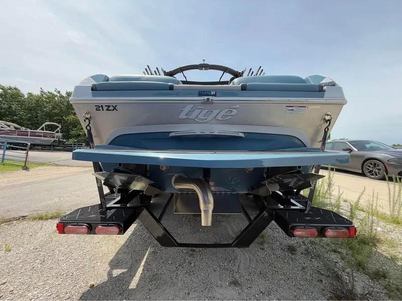 Slide: The Image of 2022 Tigé 21ZX boat rear view, showcasing sleek design and dual exhaust. - 5