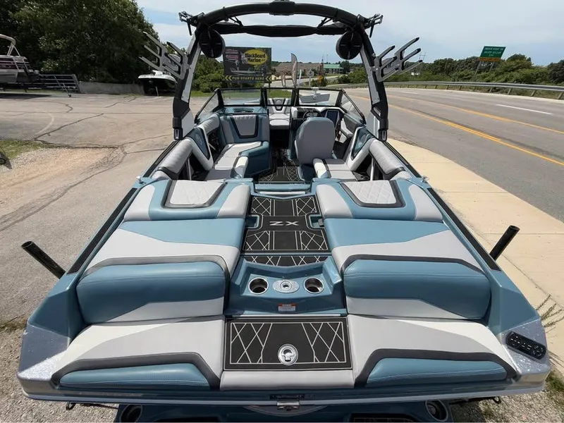 Slide: The Image of 2022 Tigé 21ZX boat interior with blue and gray seating, sleek design, and spacious layout. - 7