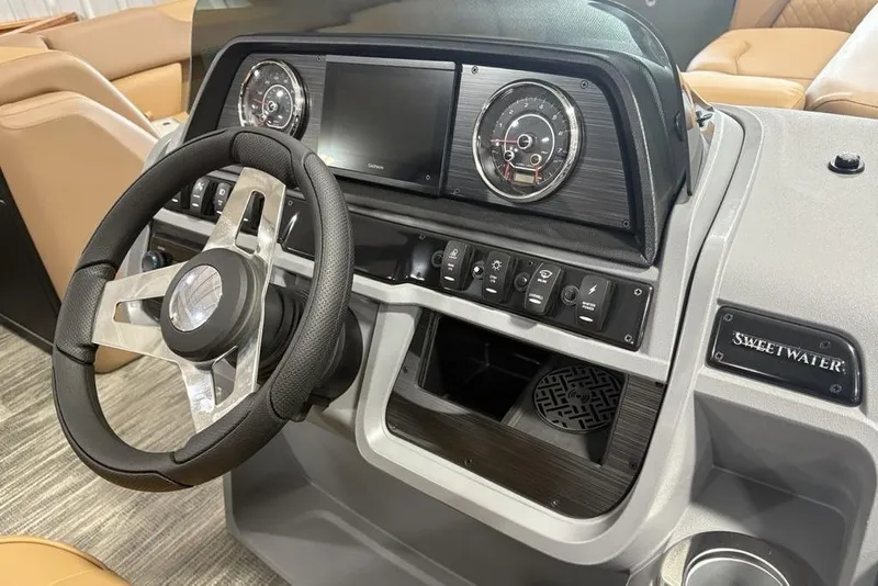 Slide: The Image of 2025 Godfrey Sweetwater 2286 SB boat dashboard with steering wheel and control panel. - 18