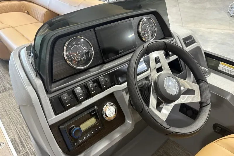 Slide: The Image of 2025 Godfrey Sweetwater 2286 SB dashboard with steering wheel and control panel. - 24