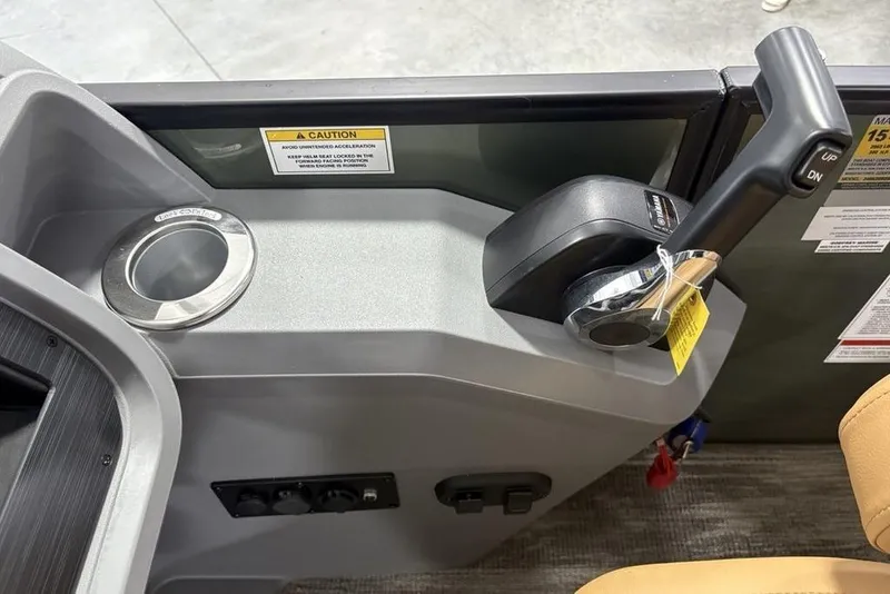 Slide: The Image of Control panel of 2025 Godfrey Sweetwater 2286 SB boat with throttle and cup holder. - 27
