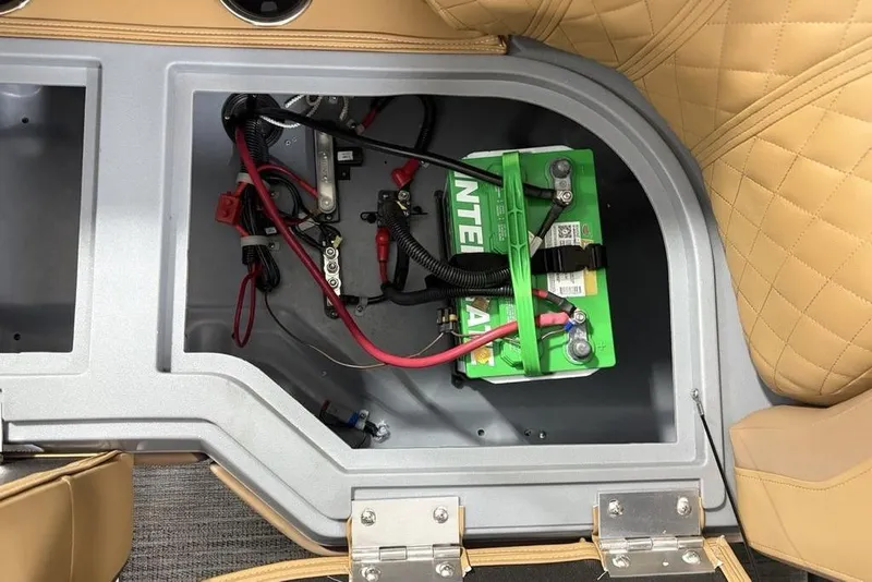 Slide: The Image of Battery compartment of 2025 Godfrey Sweetwater 2286 SB with wiring and green battery. - 35