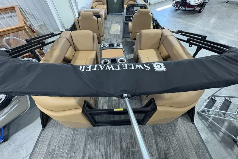 Slide: The Image of 2025 Godfrey Sweetwater 2286 SB pontoon boat interior with tan seating and center console. - 38