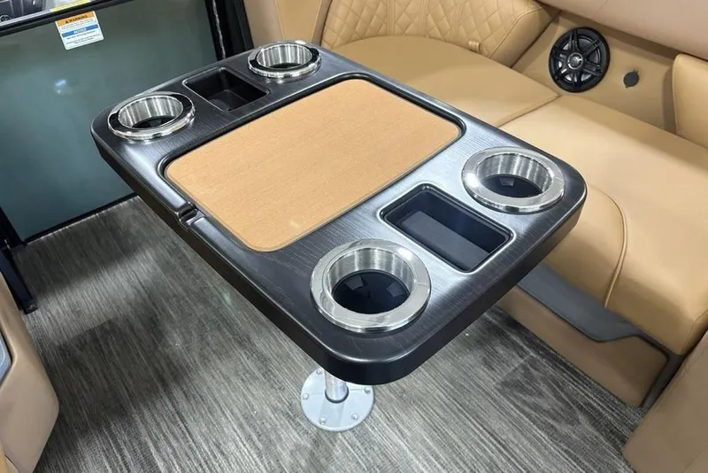 Slide: The Image of 2025 Godfrey Sweetwater 2286 SB interior table with cup holders and beige seating. - 41