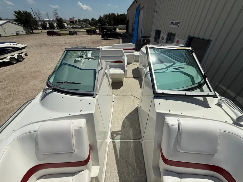Slide: The Image of 2001 Formula F-260 boat interior with white and red seating, parked outdoors. - 14