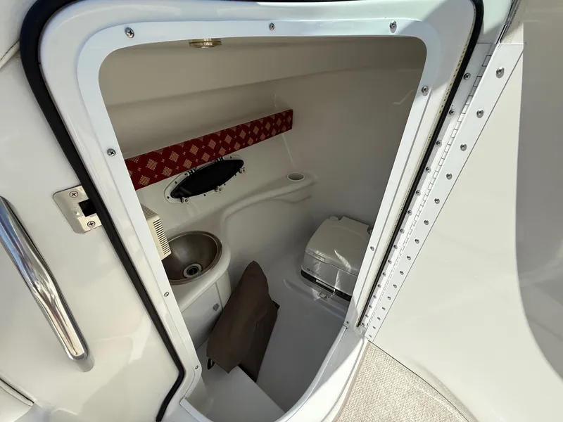 Slide: The Image of 2001 Formula F-260 boat interior with compact bathroom, sink, and toilet. - 21
