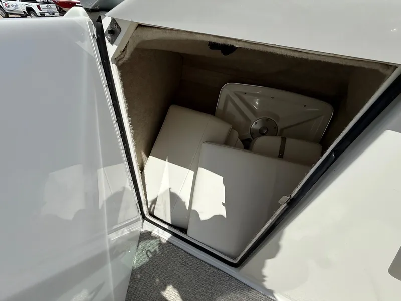 Slide: The Image of Storage compartment in a 2001 Formula F-260 boat, containing cushions and a table. - 22