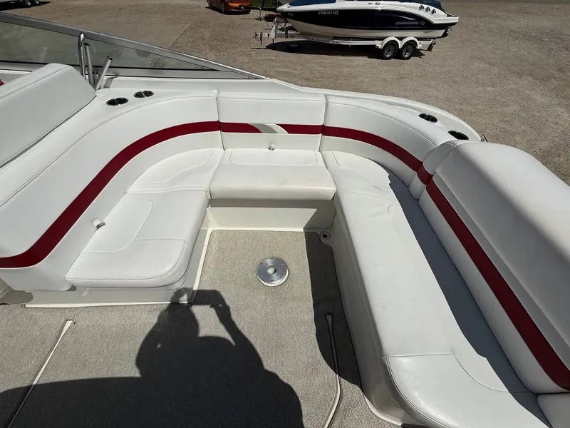 Slide: The Image of 2001 Formula F-260 boat interior with white and red seating, cup holders, and carpeted floor. - 26