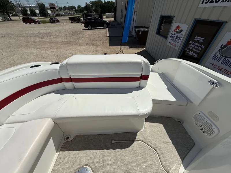 Slide: The Image of 2001 Formula F-260 boat interior with white and red seating, outdoor dealership setting. - 27