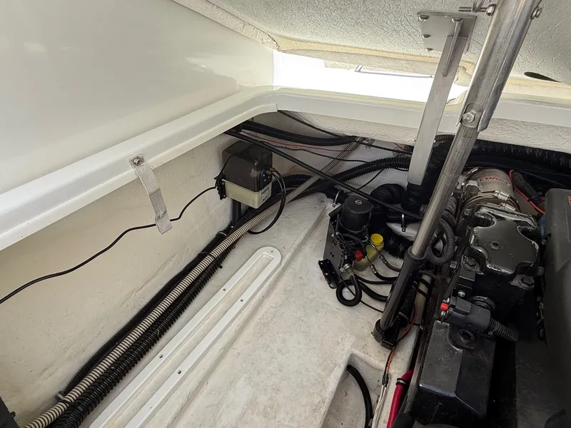 Slide: The Image of Engine compartment of a 2001 Formula F-260 boat, showcasing mechanical components and wiring. - 29
